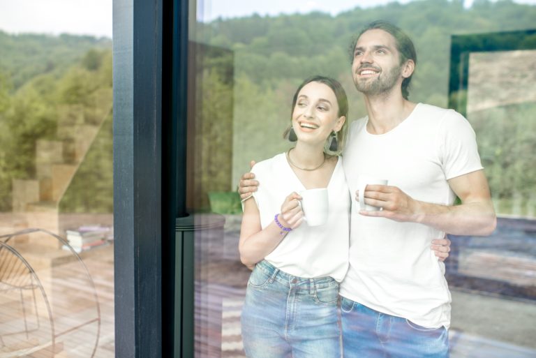 Couple looking out of clean window